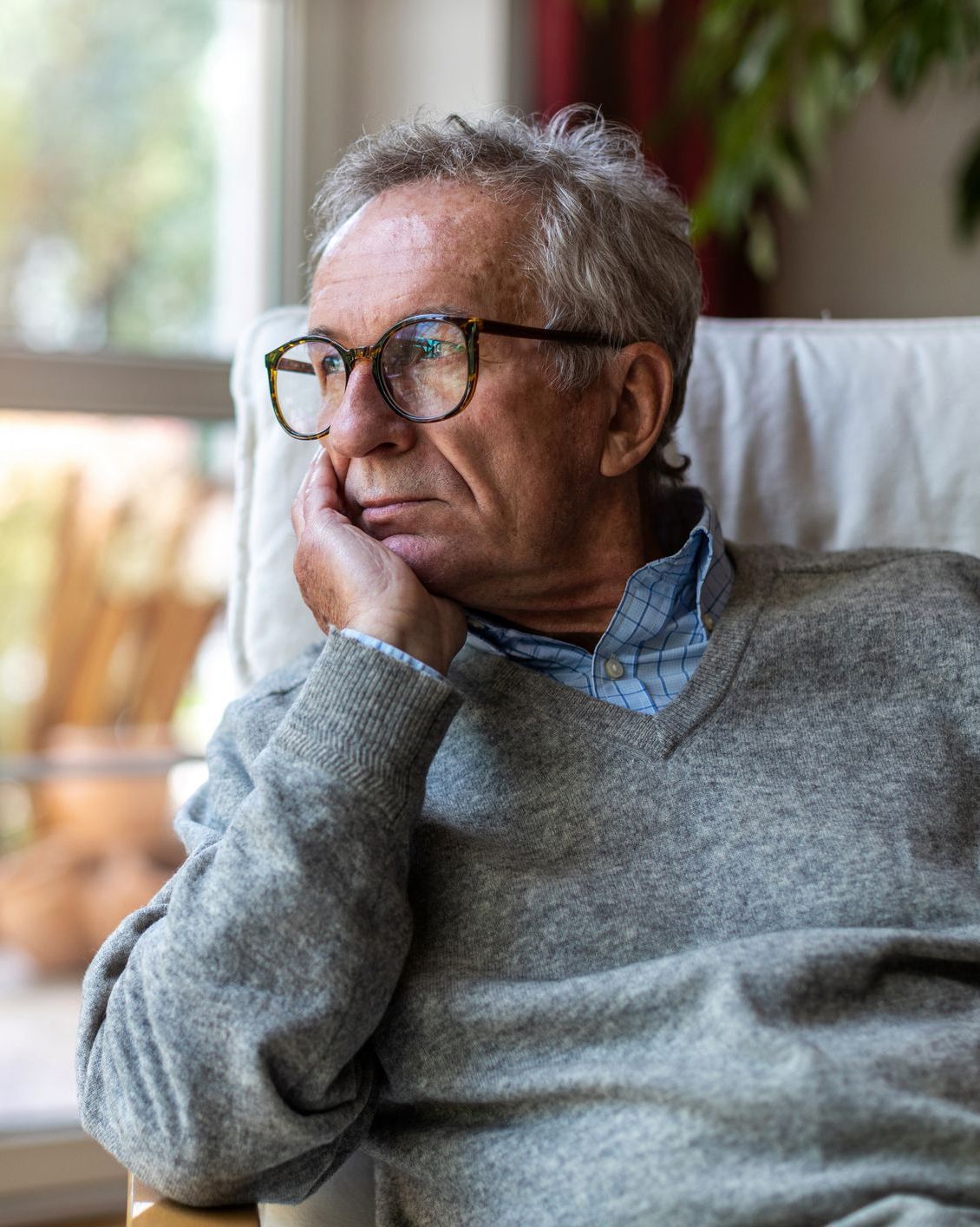 anxious older man looking out of window anxious older man looking out of window