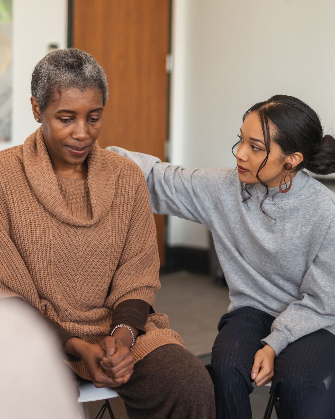 Intensive Care young woman comforting older woman