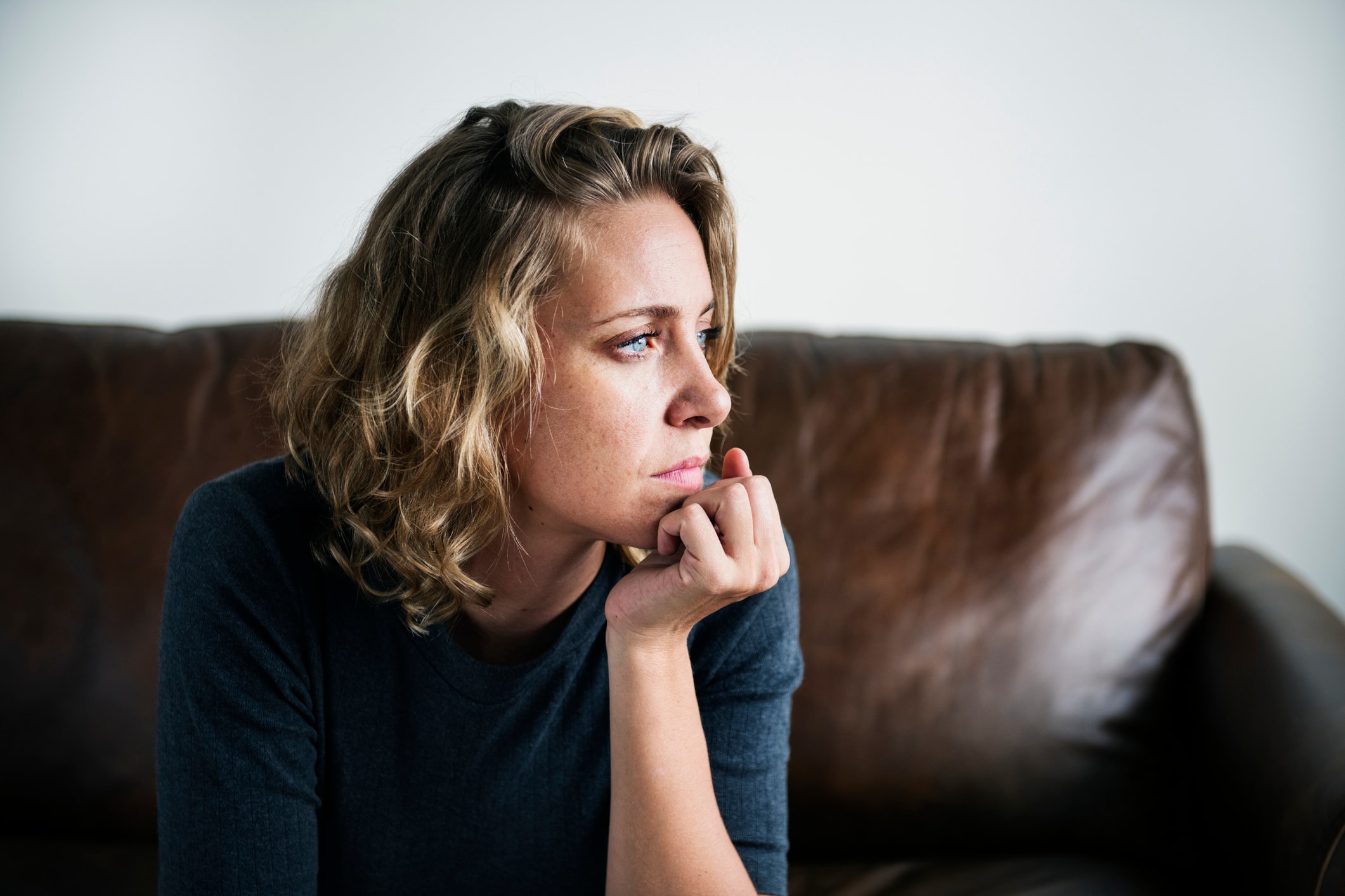 Depressed Woman Sitting by Window