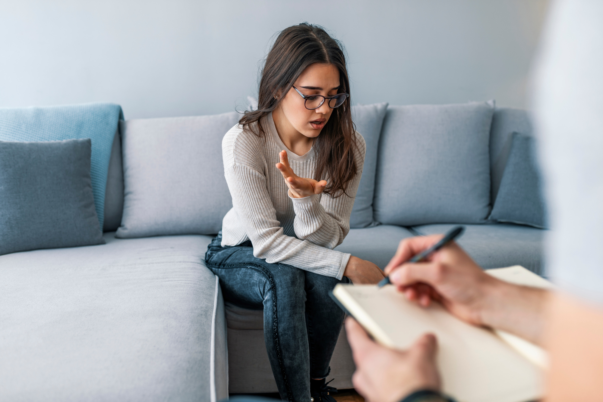 Psychologist listening to woman in trouble during therapy sessio Do I Have PTSD