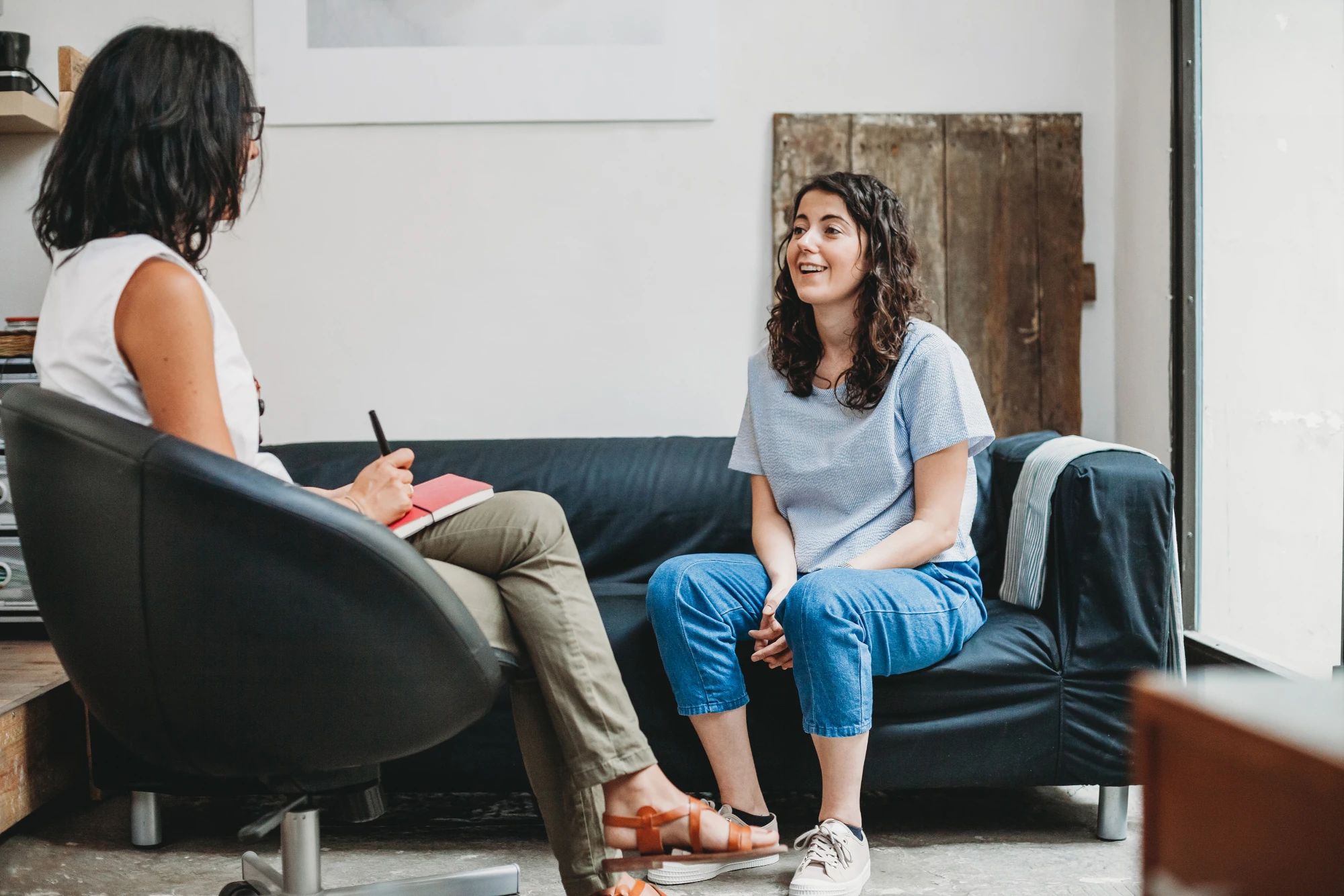 Therapist and adult client exploring the causes of high functioning anxiety during a one on one session.