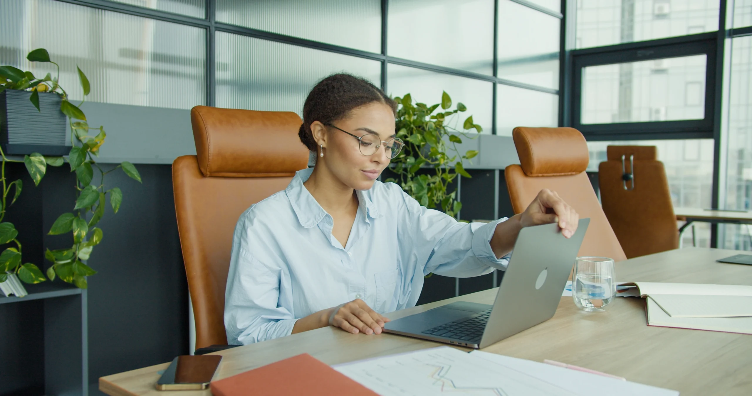 Tech worker settling in at a desk, representing a return to full capacity after treatment.