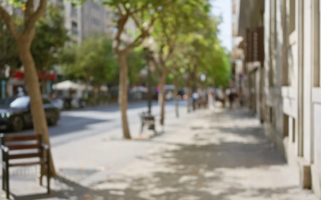A city street scene with soft motion blur, showing people and buildings out of focus